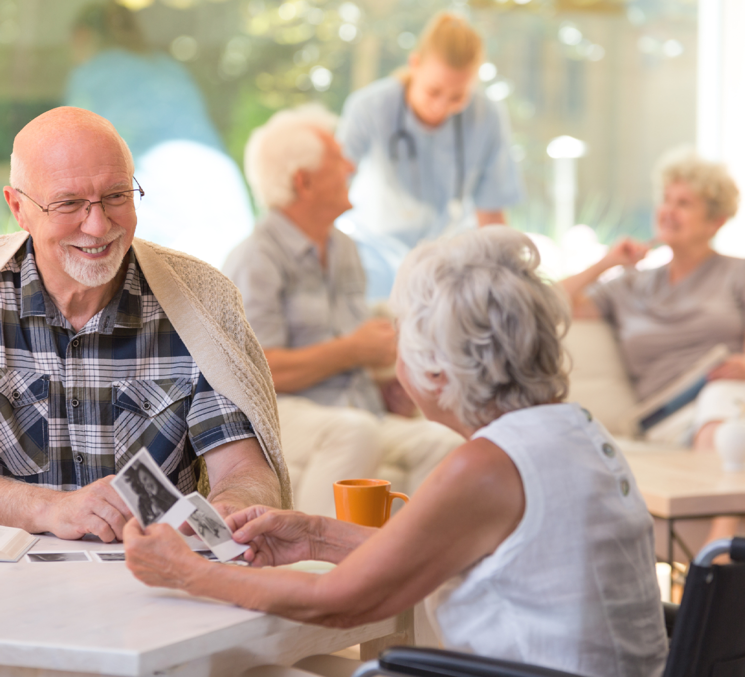 elderly man and woman looking at photos
