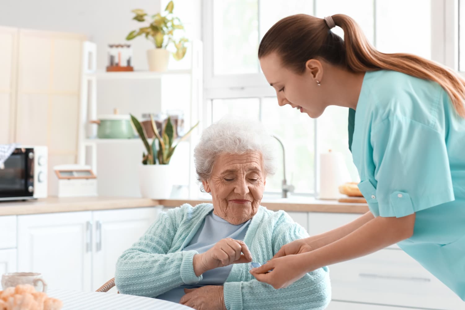 nurse giving medication to elderly person