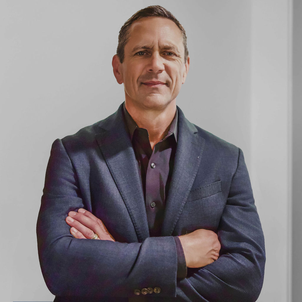 Man with arms crossed in a business suit