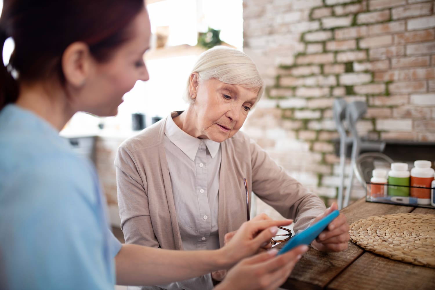 woman helping woman with her phone